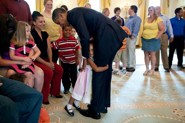 President Barack Obama gets a hug from a little girl as he greets Wounded Warriors and their families in the State Dining Room of the White House, July 5, 2011. (Official White House Photo by Pete Souza) This official White House photograph is being made available only for publication by news organizations and/or for personal use printing by the subject(s) of the photograph. The photograph may not be manipulated in any way and may not be used in commercial or political materials, advertisements, emails, products, promotions that in any way suggests approval or endorsement of the President, the First Family, or the White House.