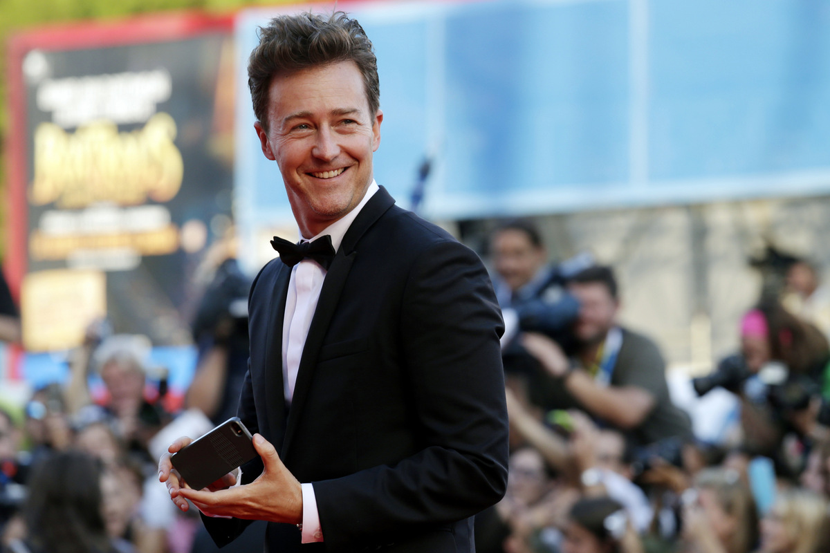 Actor Edward Norton smiles after taking a photograph of director Alejandro Gonzalez Inarritu as they arrive for the screening of Birdman during the opening ceremony for the 71st edition of the Venice Film Festival in Venice, Italy, Wednesday, Aug. 27, 2014. The 71st edition of the festival opens on Wednesday, Aug. 27th and runs until Sept. 6. (AP Photo/David Azia)