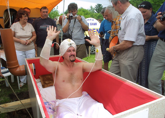 CZECH REPUBLIC OUT Czech fakir Zdenek Zahradka (Little Garden in English!) waves to his supporter while emerging from a wooden coffin after he survived 10 days buried underground without food and water, setting a new world record. Inside the coffin, Zahradka aka Ben Ghan, was connected with the outside world only by a ventilation pipe. After the temperature rose inside the coffin, however, his friends cut another hole in the lid. Zahradka, said that he had spent most of the time in the coffin sleeping or contemplating and sometimes spoke to friends through the pipe. The most difficult thing had been severe thirst, he added. "While I was underground I thought about all the things happening in the world, and I realized that human live is so futile that we must be glad for the time given to us. Zahradka, who lives in Jaromer, 170 kilometres east of Prague, beat the previous world record for being buried alive by four days and will apply to be registered in the Guinness Book of World Records. AFP PHOTO-MAFA/ONDREJ LITTERA