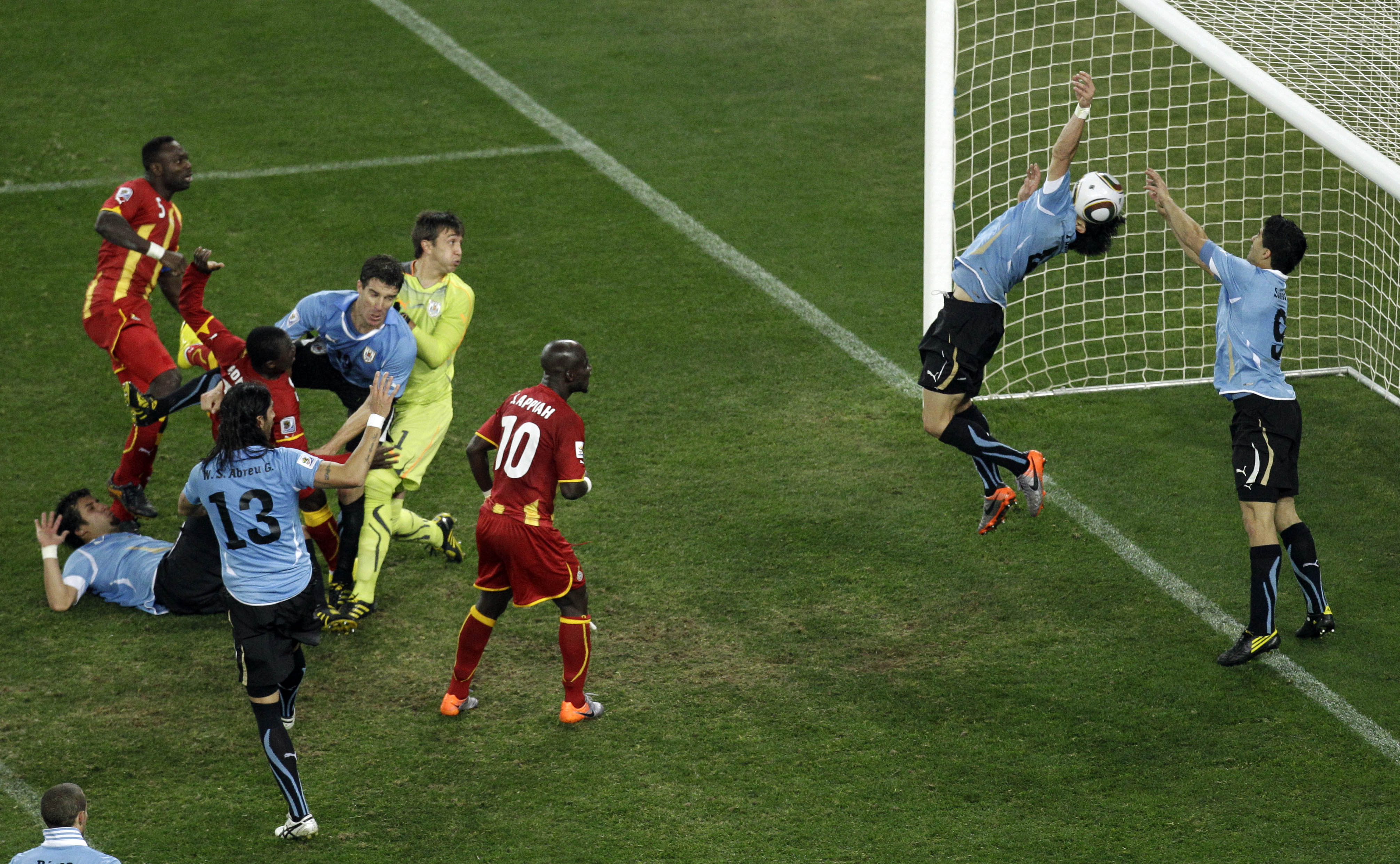 Uruguay's Luis Suarez, right, reaches his hands to the ball to give away a penalty during the World Cup quarterfinal soccer match between Uruguay and Ghana at Soccer City in Johannesburg, South Africa, Friday, July 2, 2010. (AP Photo/Themba Hadebe)