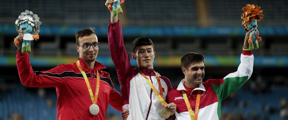 RIO DE JANEIRO, BRAZIL - SEPTEMBER 09: (L-R) Silver medalist Mahdi Afri of Morocco, gold medalist Qichao Sun of China and bronze medalist Luis Goncalves of Portugal celebrate on the podium at the medal ceremony for the Men's 400m T12 Final during day 2 of the Rio 2016 Paralympic Games at the Olympic Stadium on September 9, 2016 in Rio de Janeiro, Brazil. (Photo by Alexandre Loureiro/Getty Images)