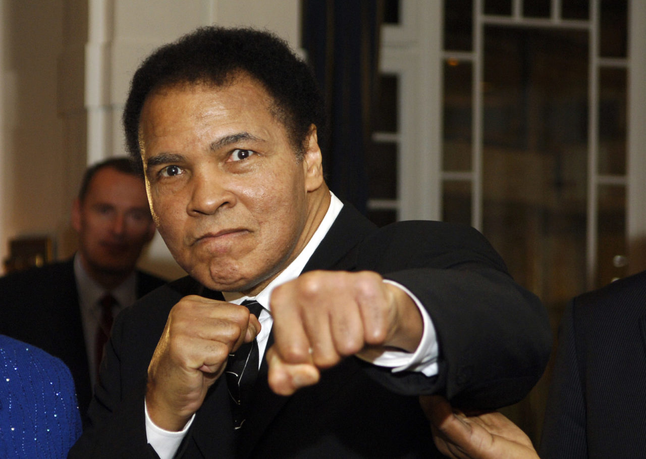 US former heavyweight boxing champion Muhammad Ali gives a punch in front of photographers at hotel Belvedere in Davos 28 January 2006. AFP PHOTO ERIC FEFERBERG